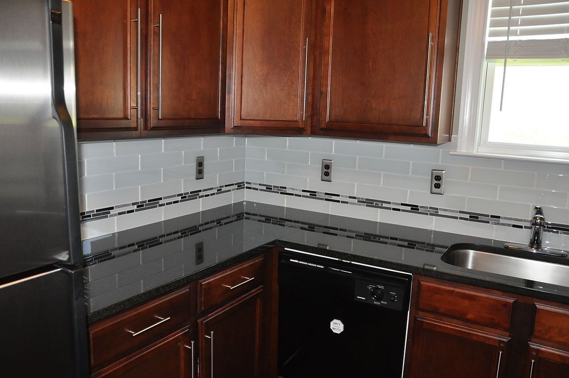 A kitchen with stainless steel appliances and wooden cabinets