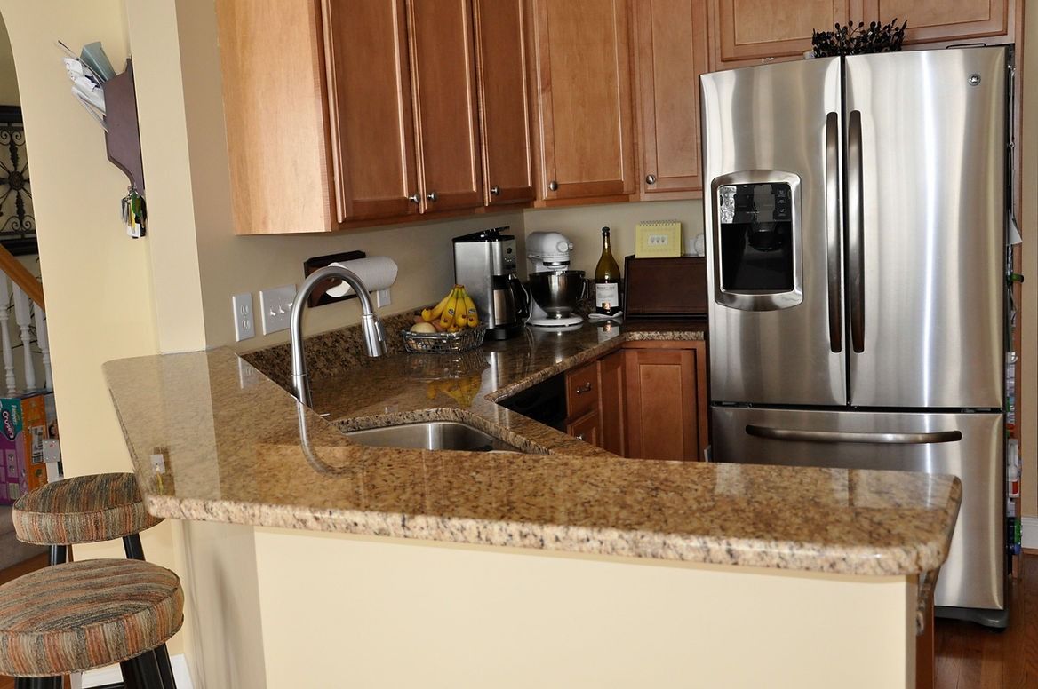 A kitchen with stainless steel appliances and granite counter tops