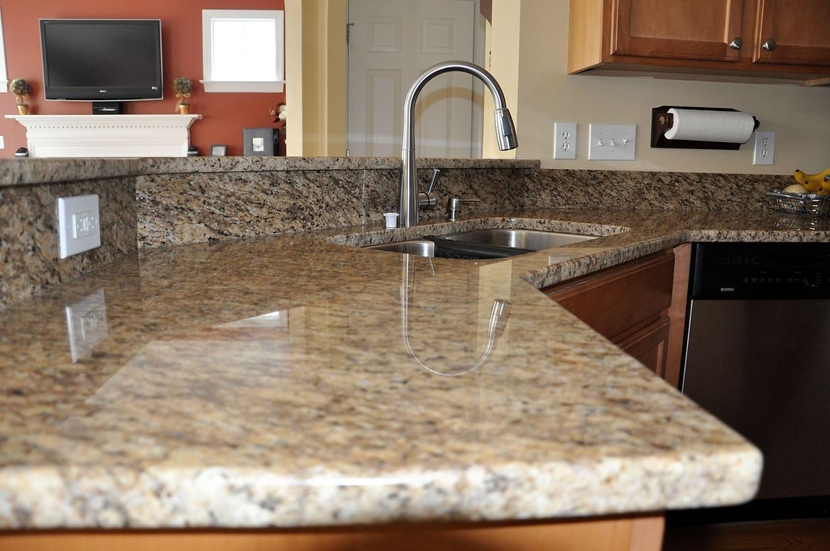 A kitchen with granite counter tops and a sink.