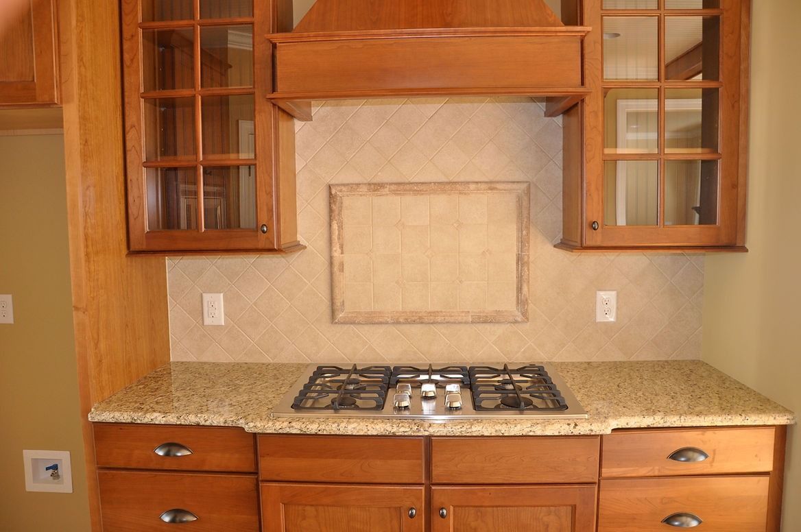 A kitchen with wooden cabinets and a stove top oven