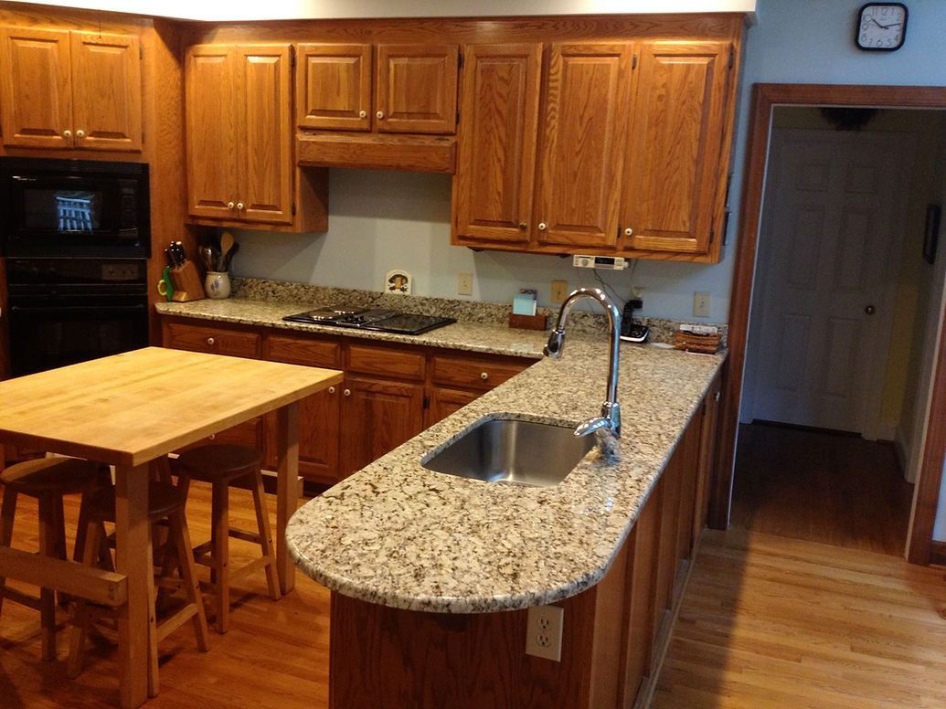 A kitchen with wooden cabinets and granite counter tops