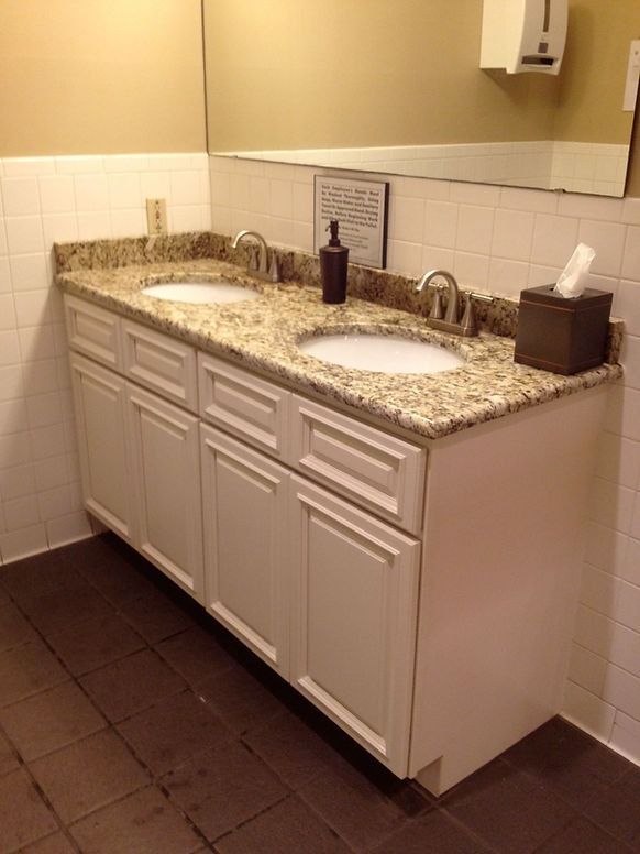 A bathroom with two sinks and a mirror