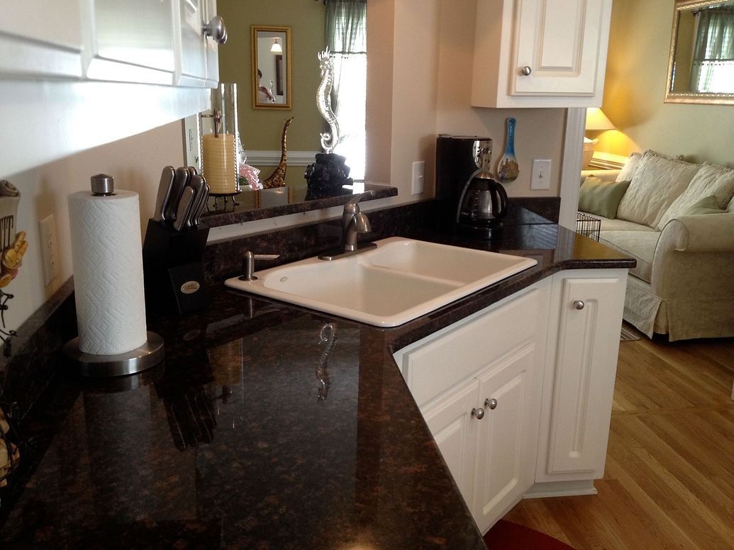A kitchen with a sink and a paper towel holder