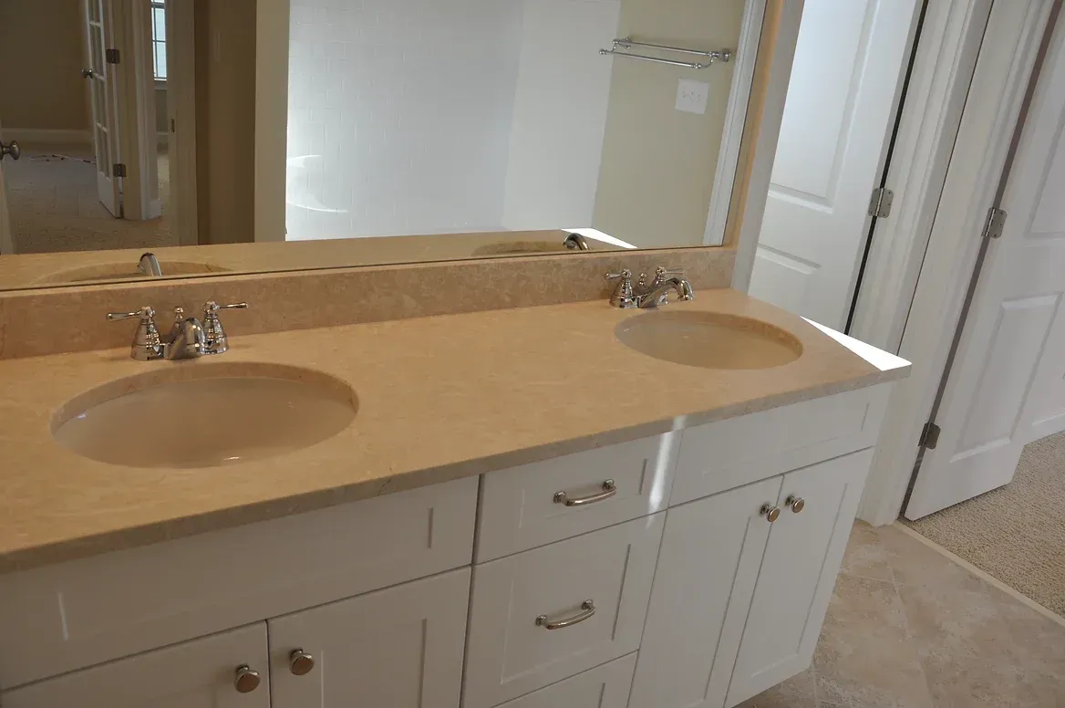 A bathroom with two sinks and a mirror
