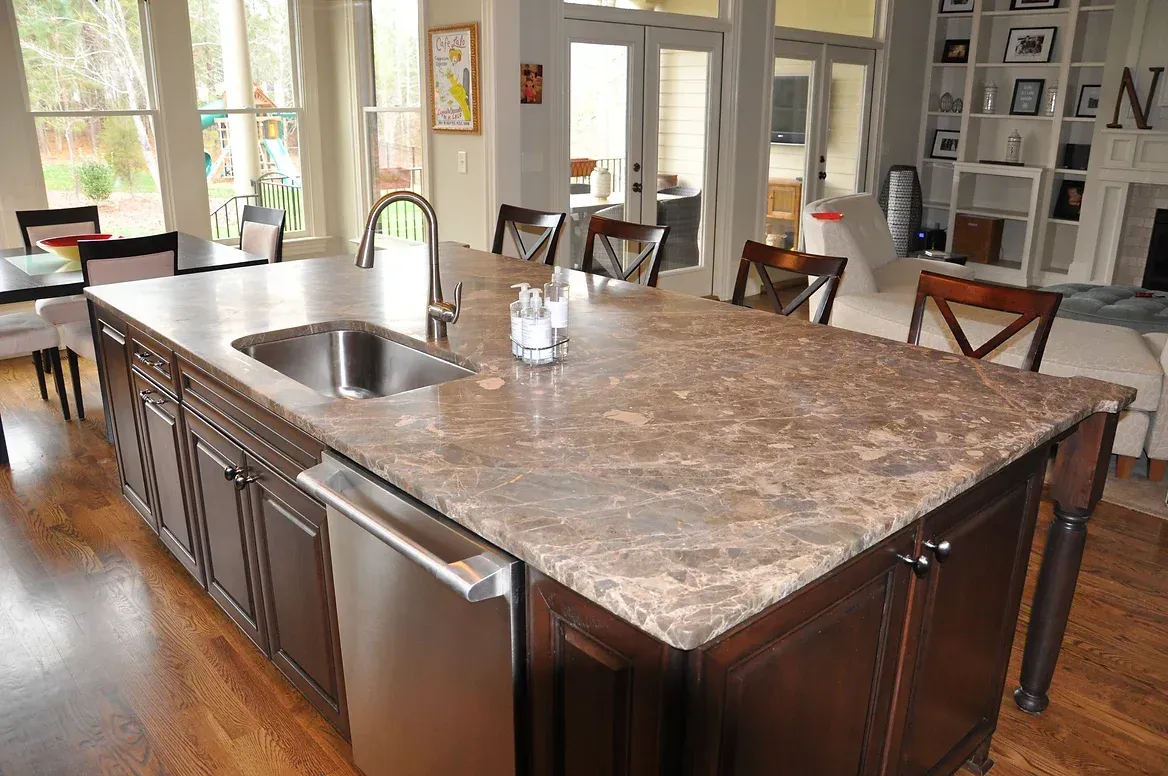 A kitchen with a large island and a sink.