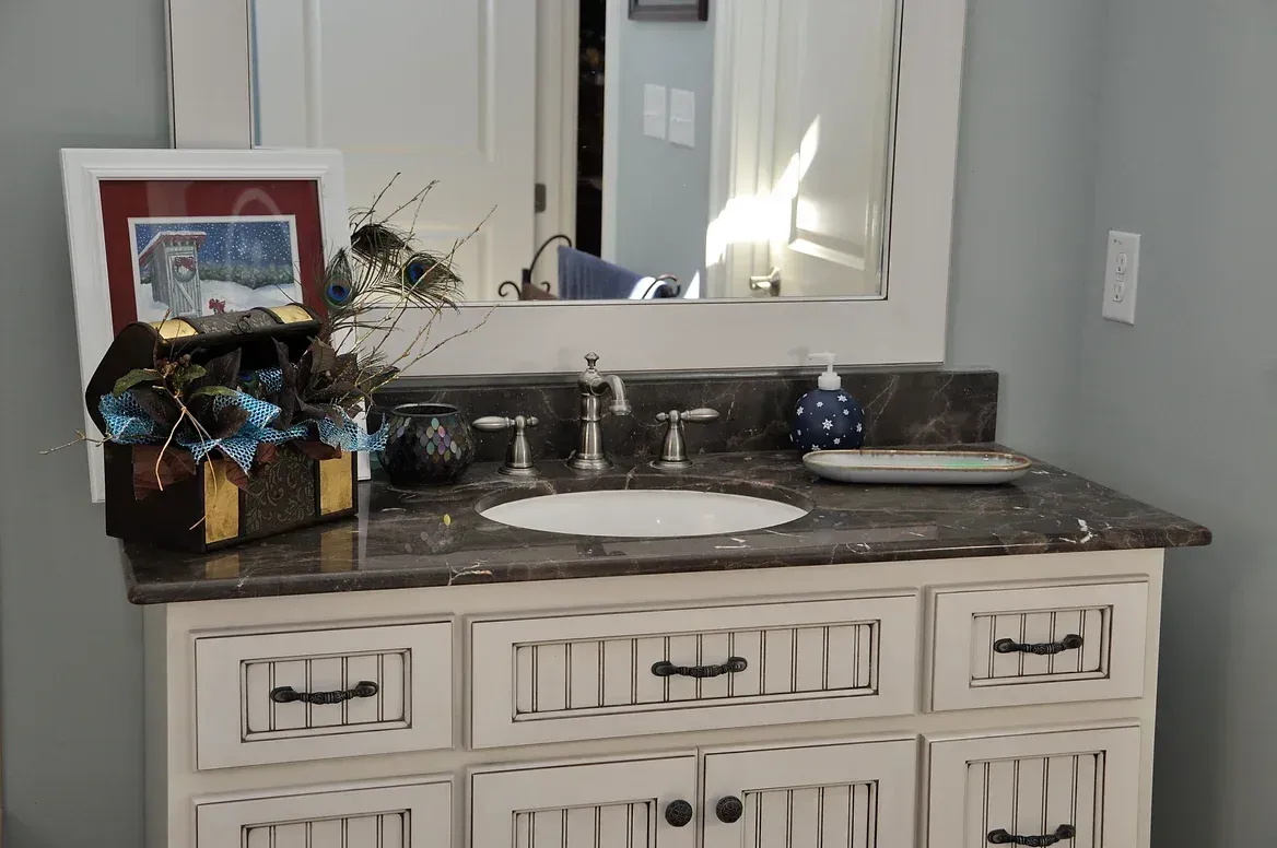 A bathroom vanity with a sink and a mirror