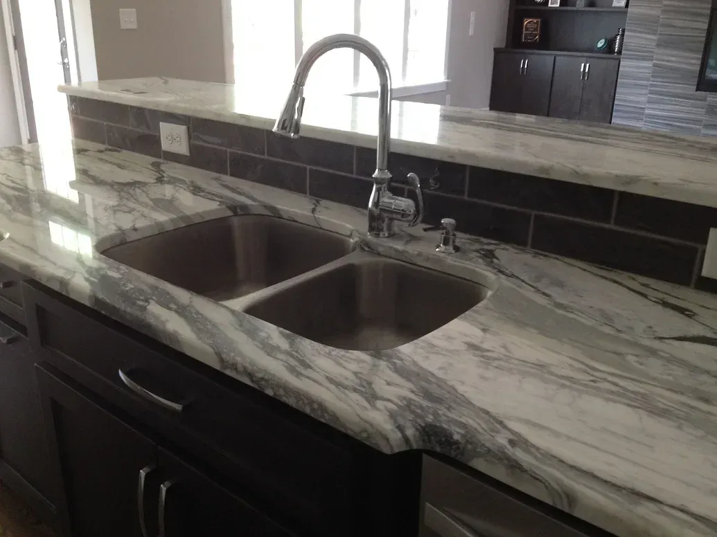 A kitchen with a double sink and a faucet.