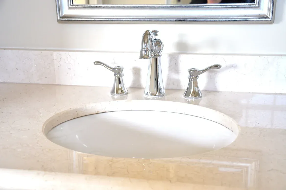 A bathroom sink with a mirror above it and a faucet.