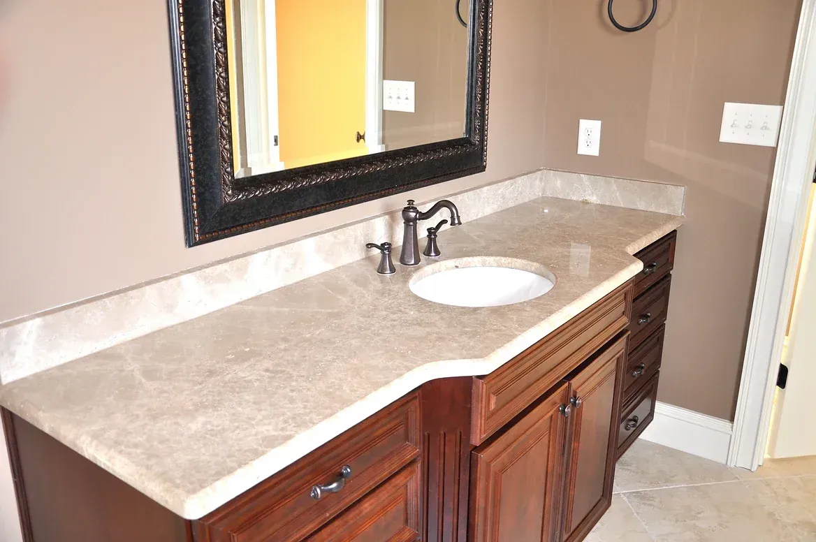 A bathroom with a sink and a mirror on the wall.