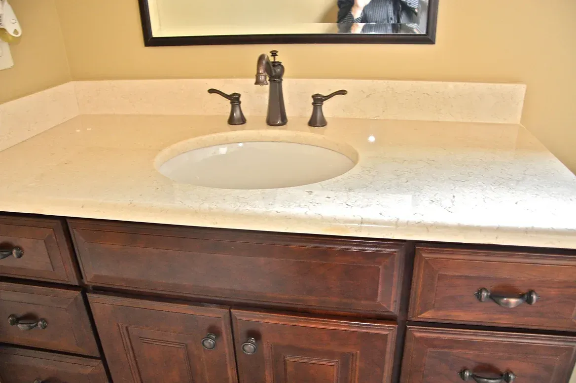 A bathroom vanity with a sink and a mirror.