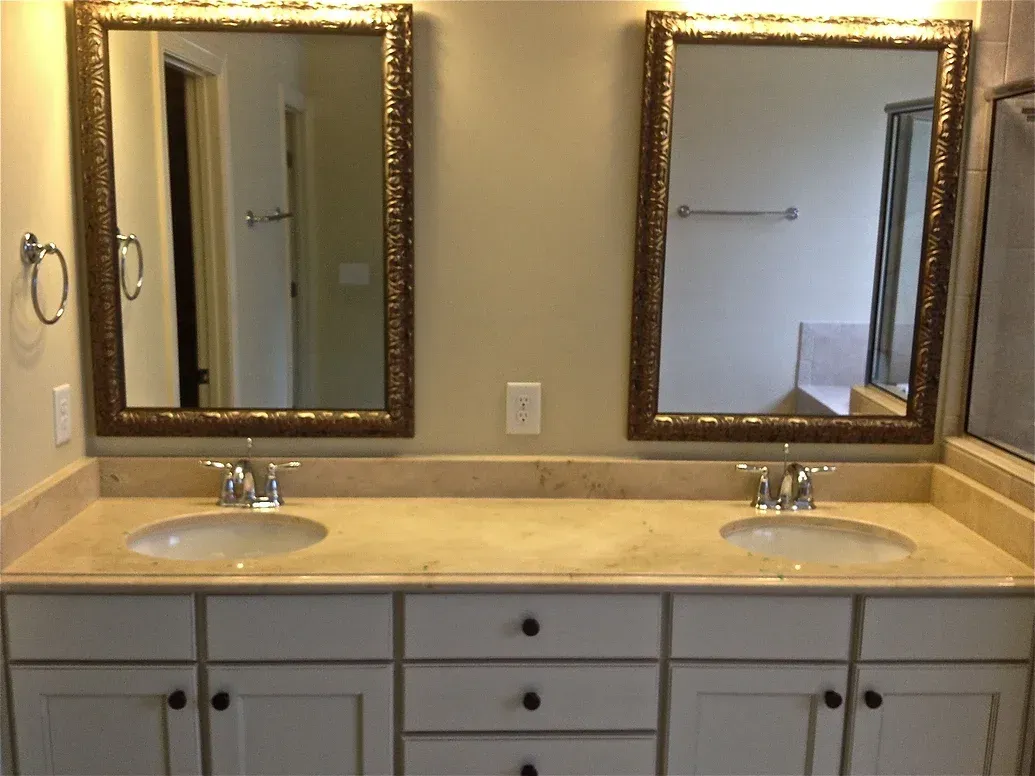 A bathroom with two sinks and two mirrors