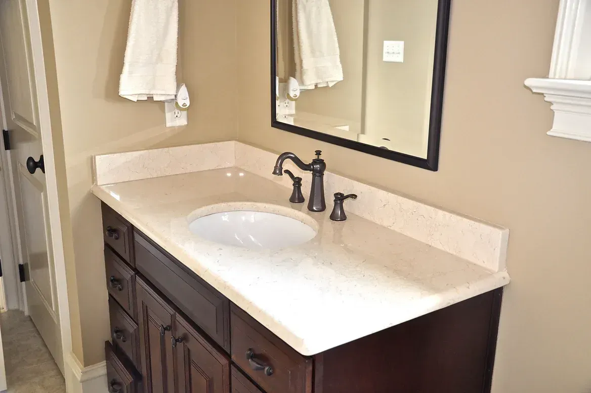 A bathroom vanity with a sink and a mirror