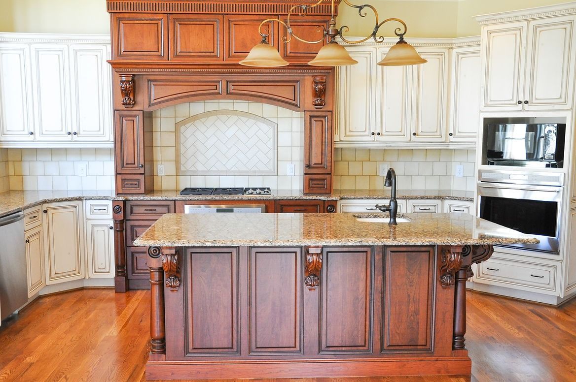 A kitchen with wooden cabinets and granite counter tops