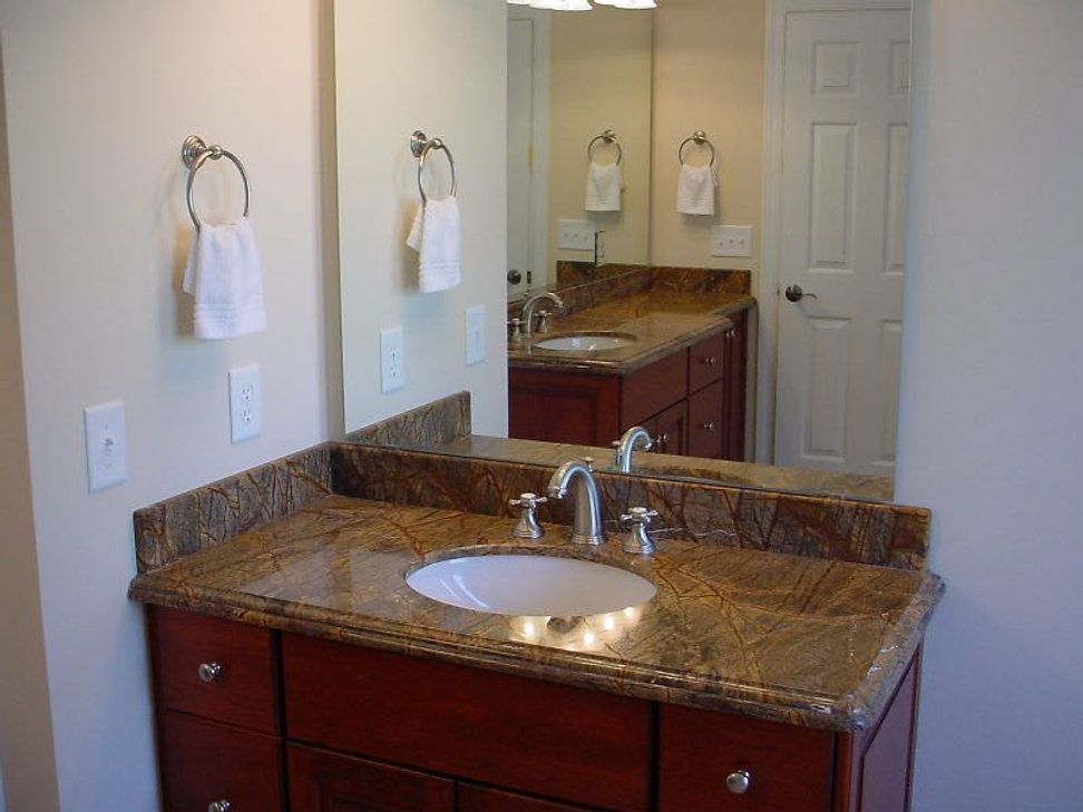 A bathroom with two sinks and a large mirror