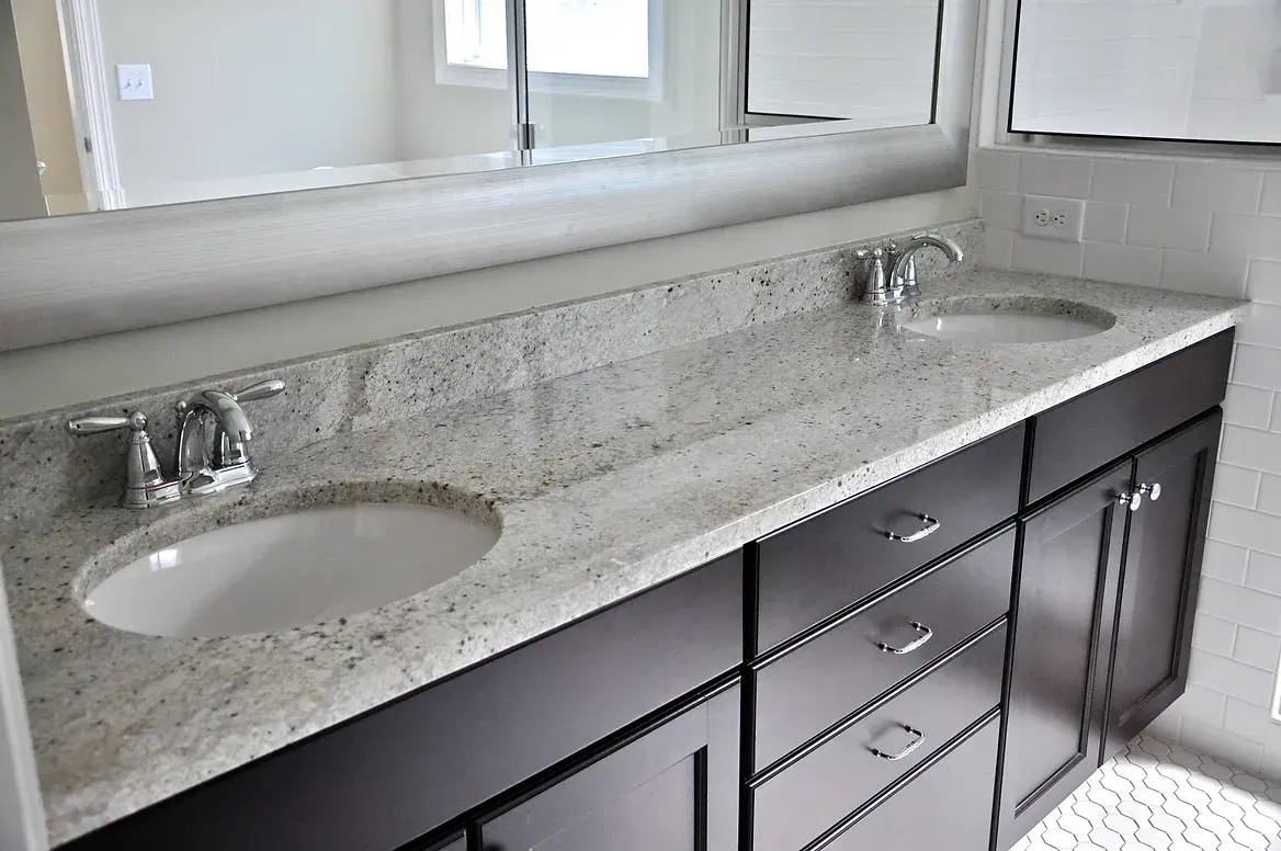 A bathroom with two sinks and a large mirror.