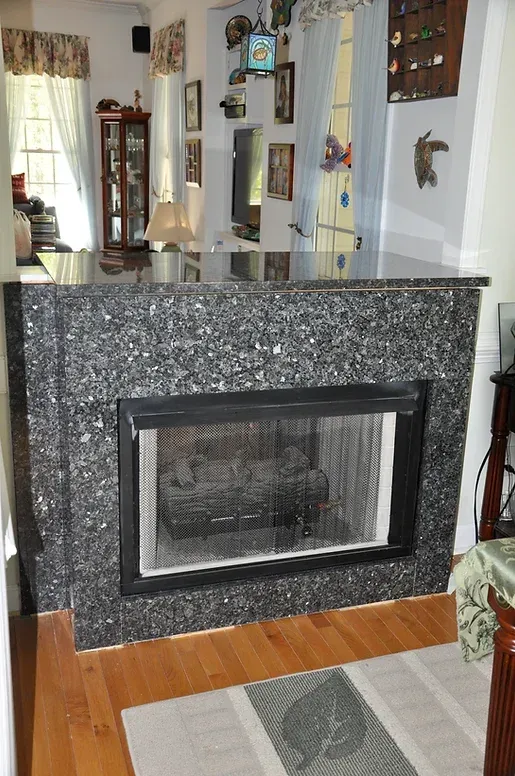 A living room with a fireplace and a rug