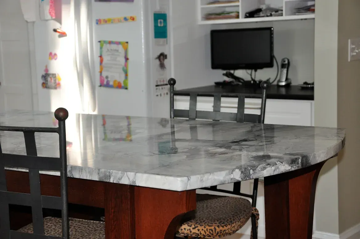 A dining room table with a computer on it