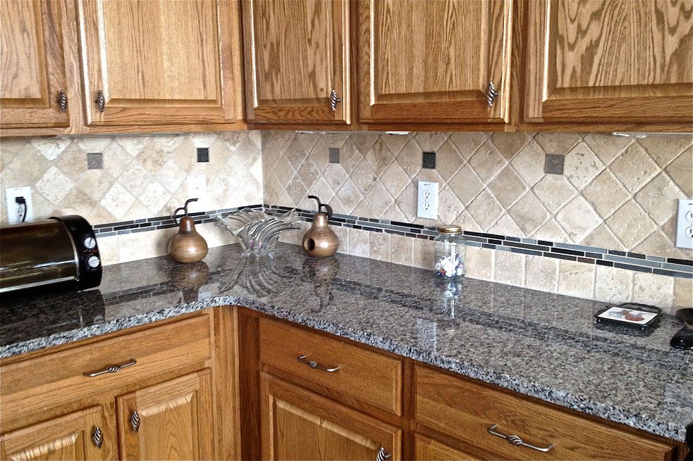 A kitchen with granite counter tops and wooden cabinets