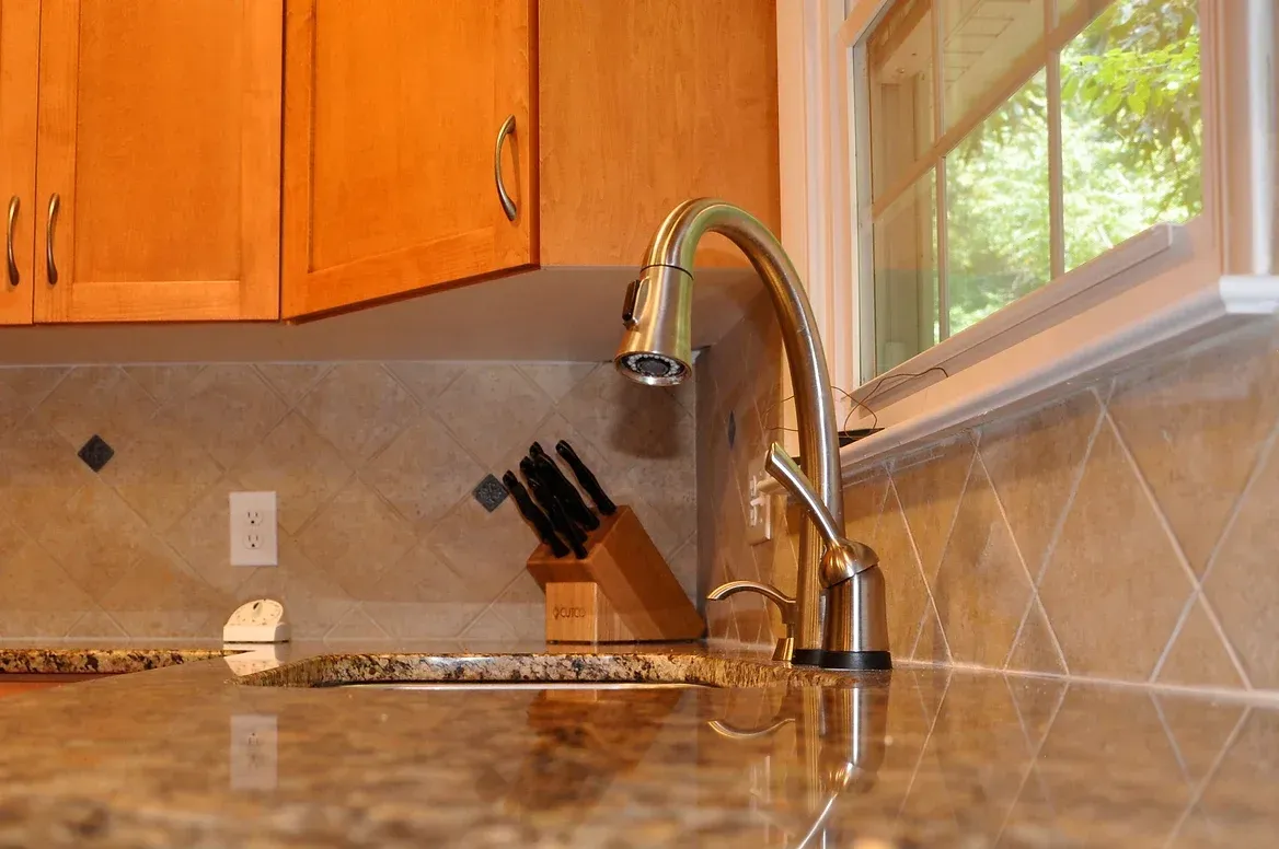A kitchen counter with a sink and a window