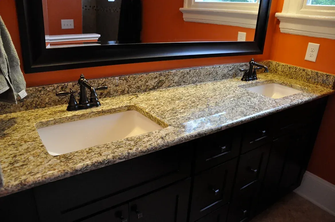 A bathroom with two sinks and a mirror.