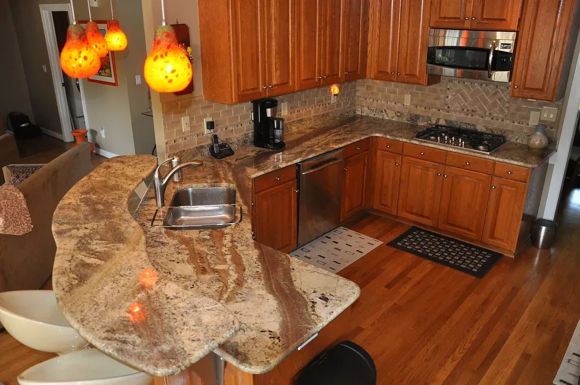 A kitchen with wooden cabinets and granite counter tops