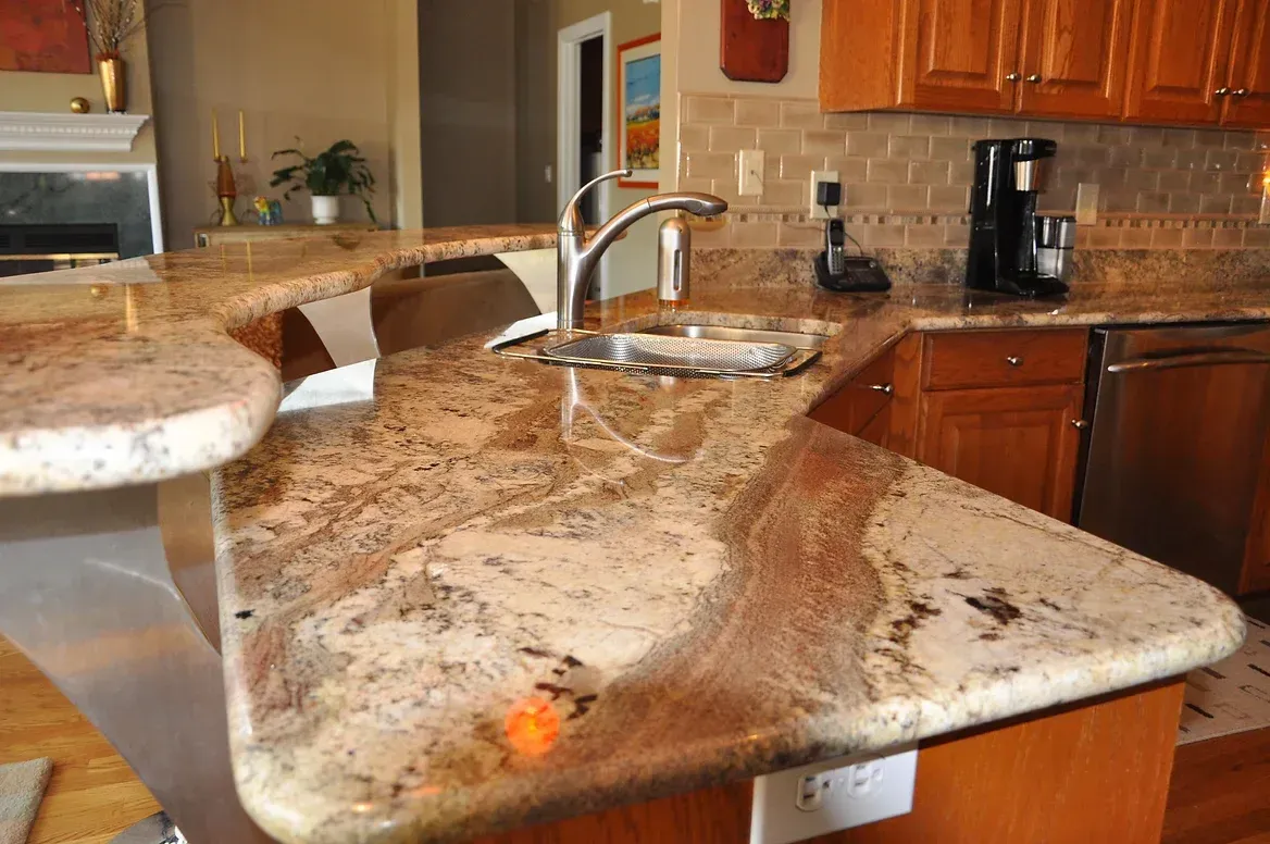 A kitchen with a granite counter top and a sink