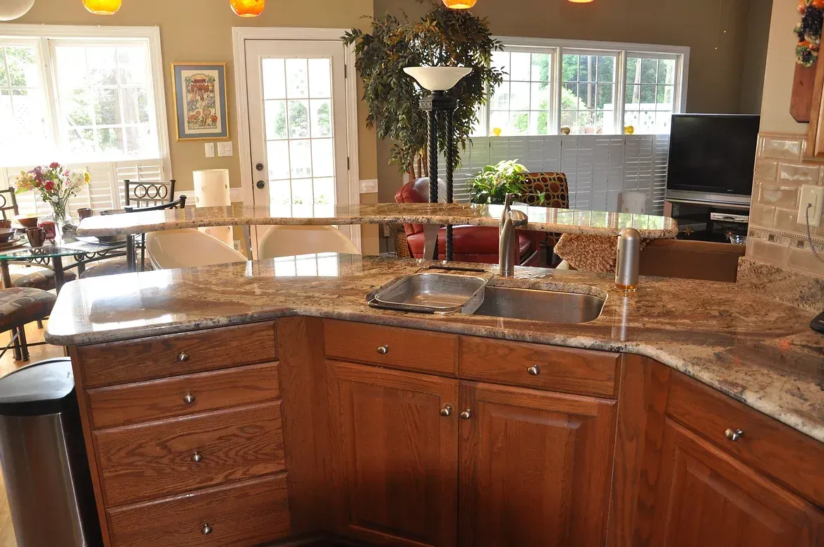 A kitchen with granite counter tops and wooden cabinets