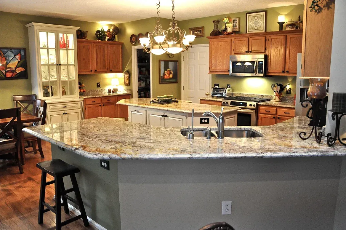 A kitchen with granite counter tops and wooden cabinets