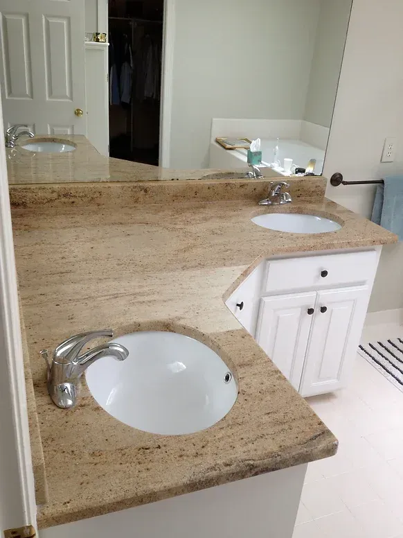 A bathroom with two sinks and a large mirror