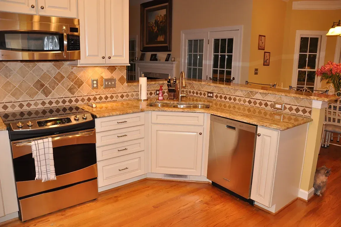 A kitchen with stainless steel appliances and white cabinets