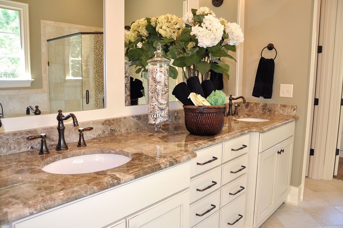 A bathroom with two sinks and a large mirror