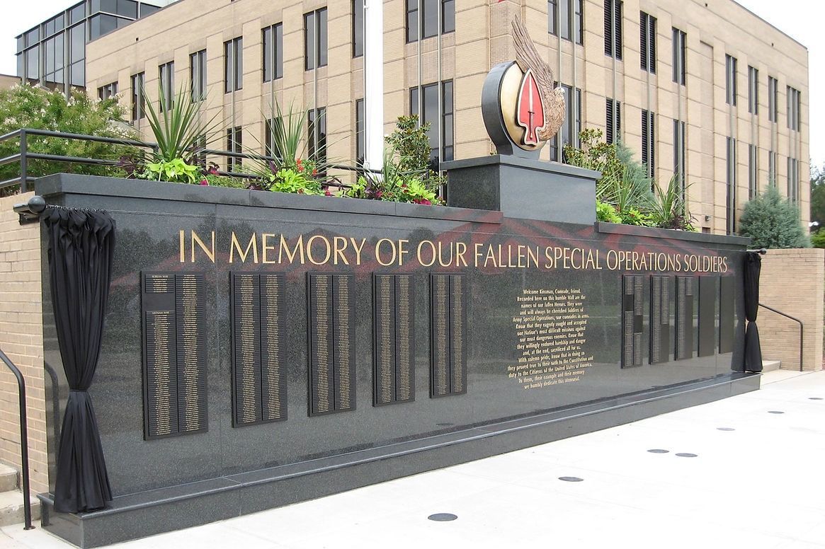 A large black wall with the words in memory of on it