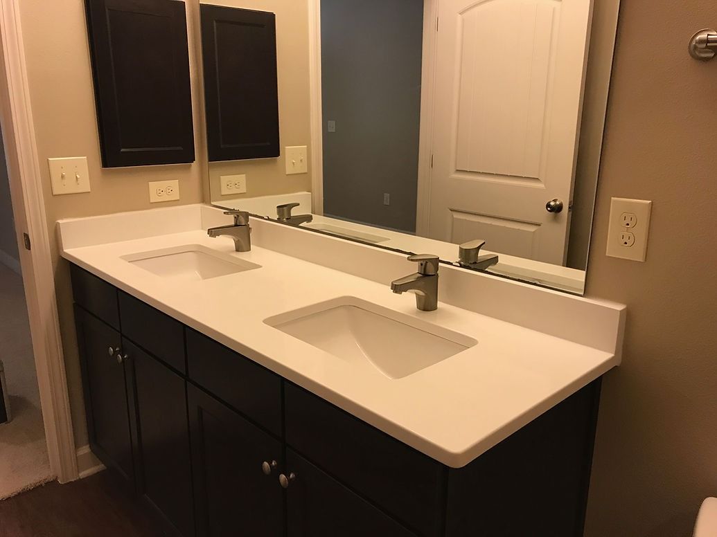 A bathroom with two sinks and a large mirror.