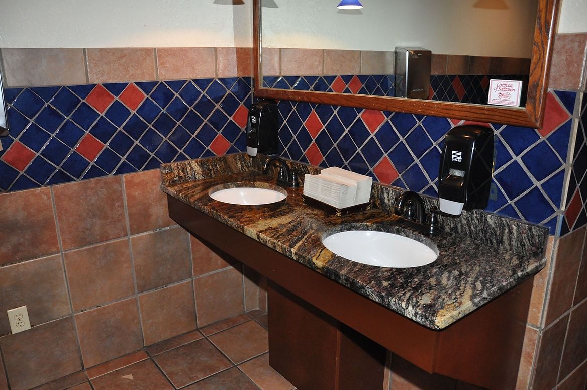 A bathroom with two sinks and a mirror