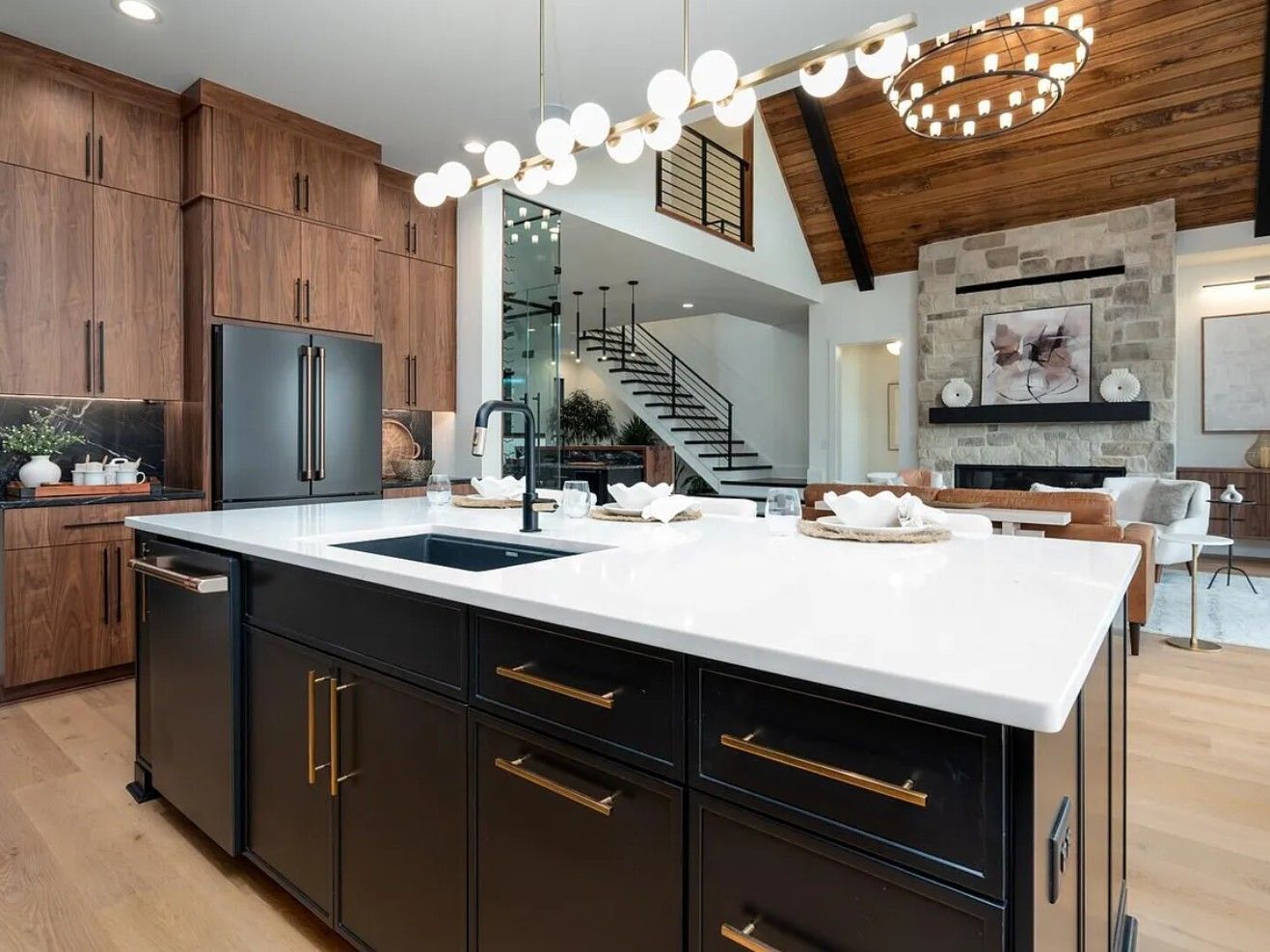 Modern kitchen with black island, white countertop, and wood cabinets.