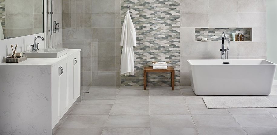 A bathroom with a bathtub , sink , mirror and walk in shower.