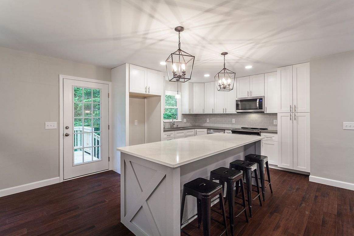 There is a large island in the middle of the kitchen.