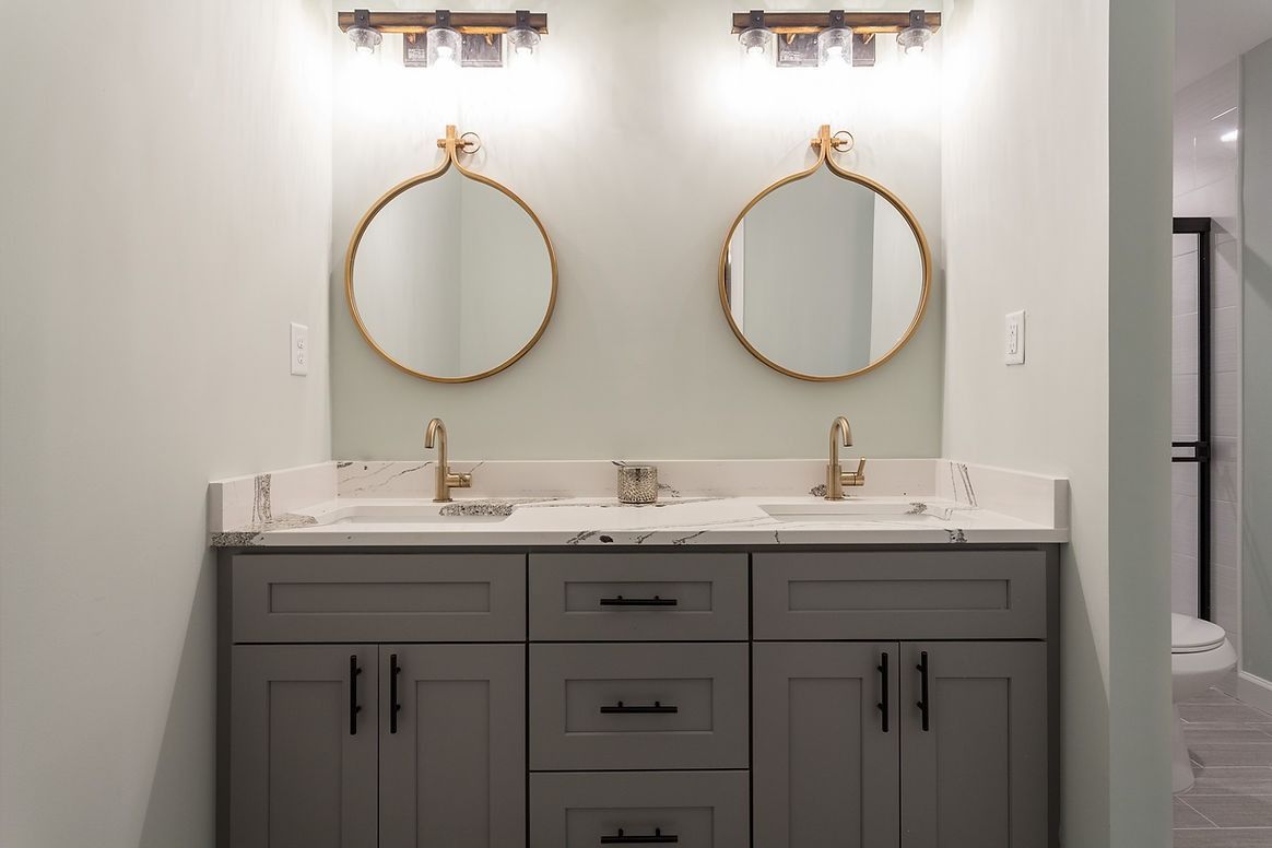 A bathroom with two sinks and two mirrors.