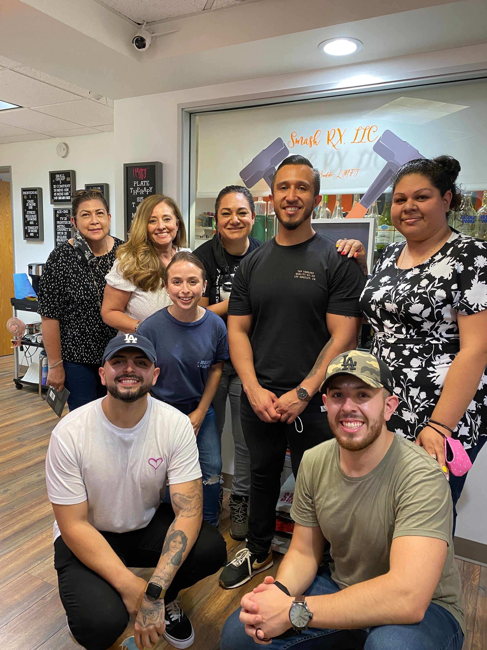 A group of people are posing for a picture in a room.