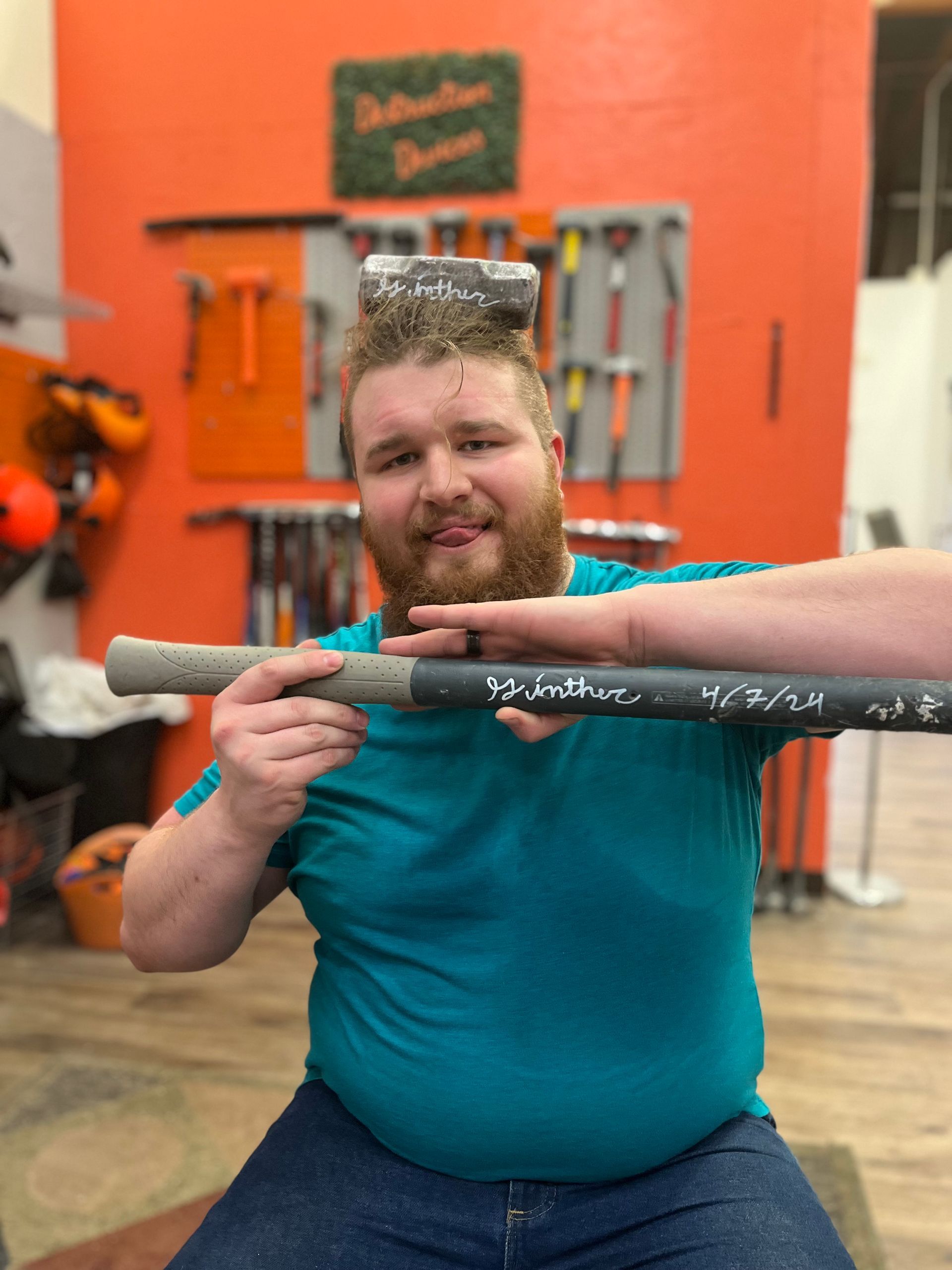 A man holding a baseball bat horizontally.