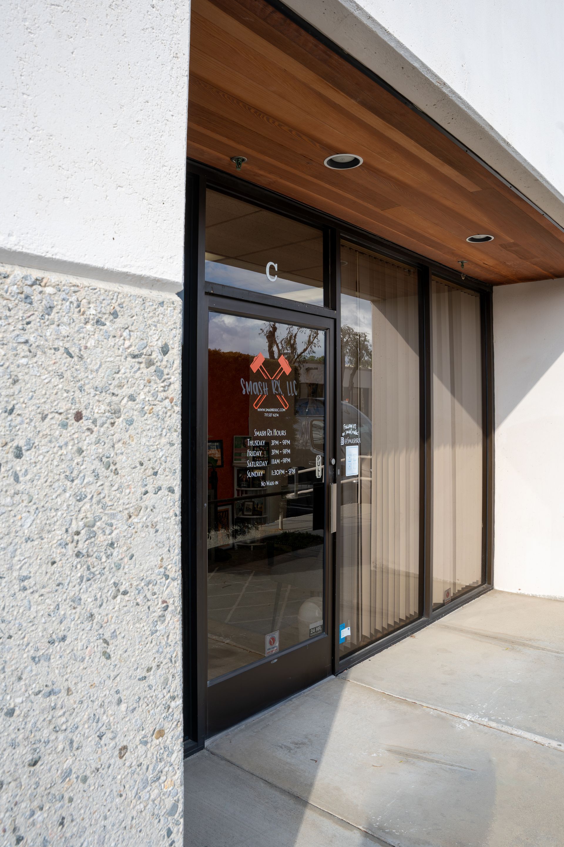 A building with a glass door and a wooden ceiling.