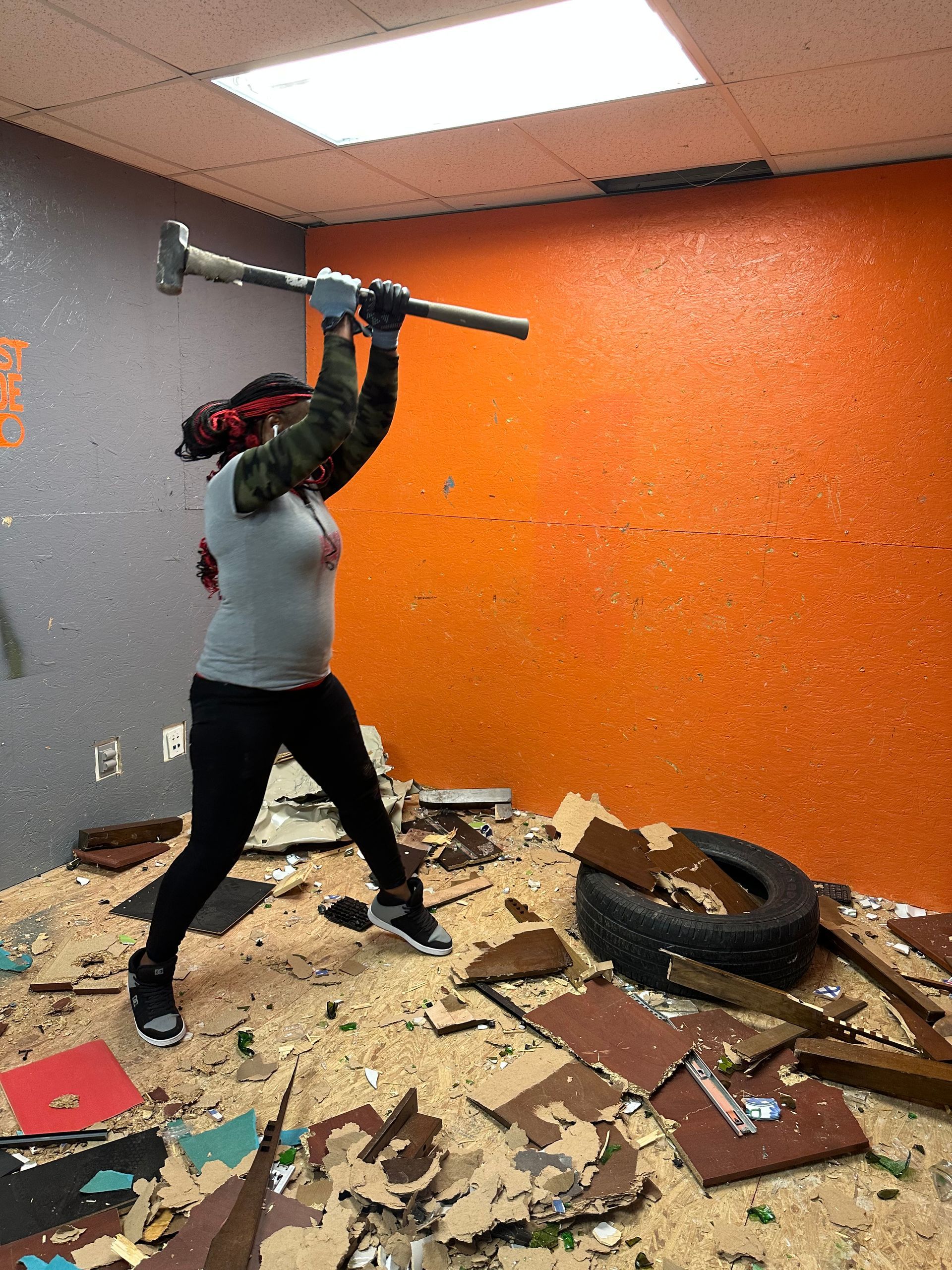 A woman about to hit a tire.