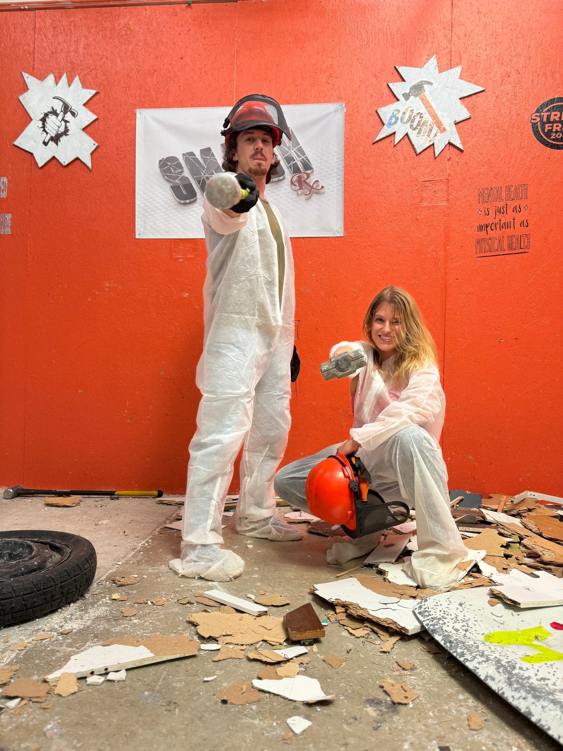 A man and a woman are standing next to each other in a room.