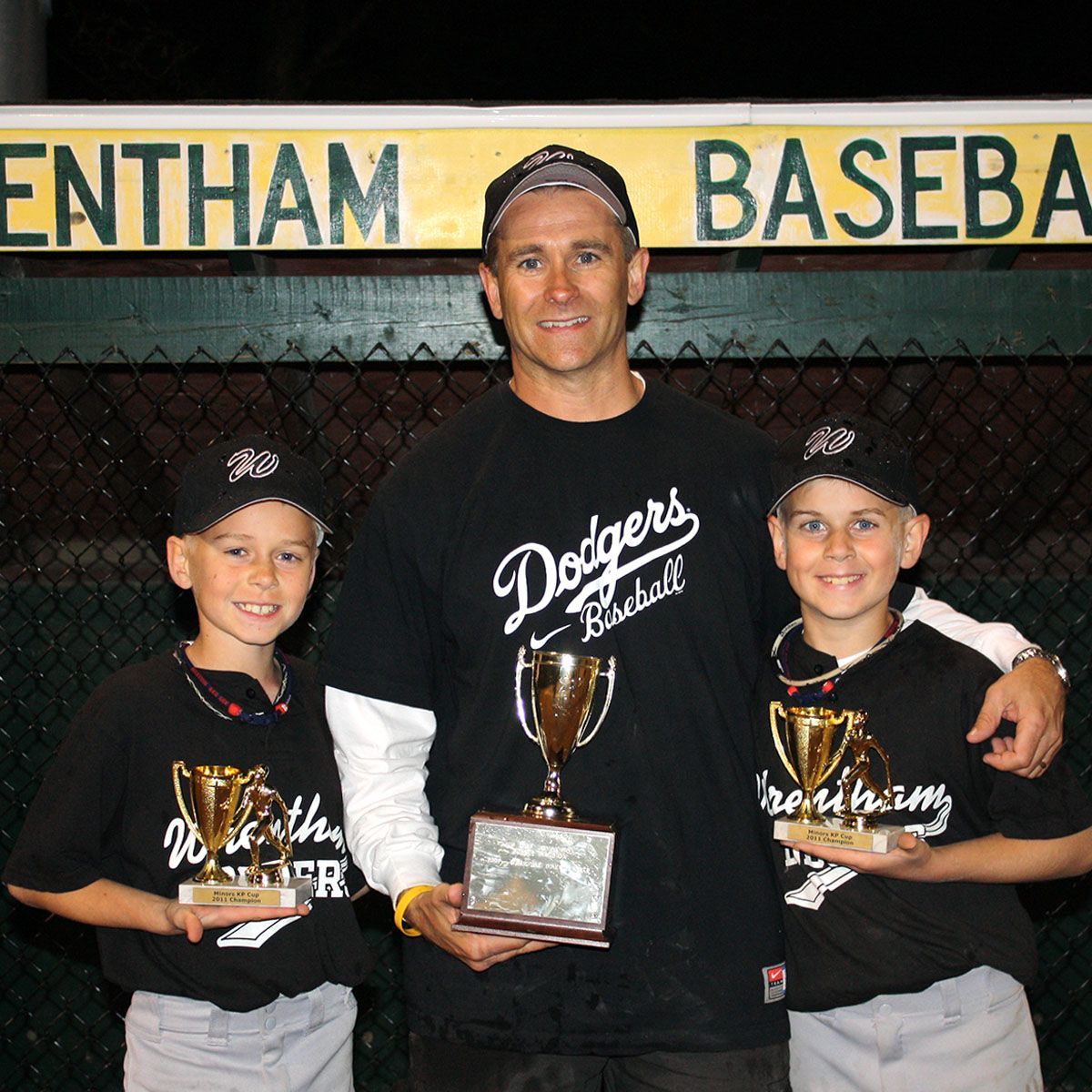 Dan Wood and his sons holding trophies