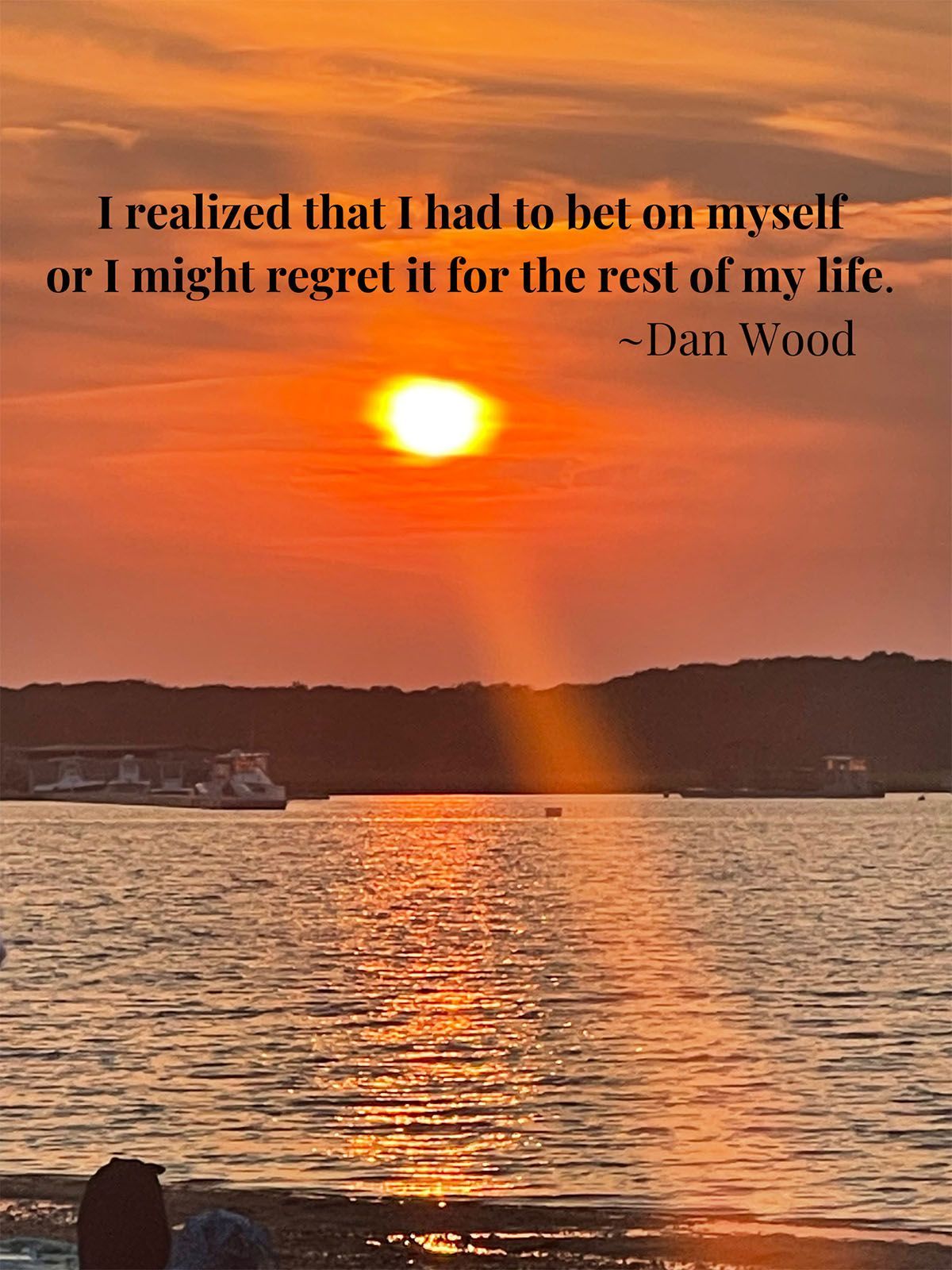 A photo of a beach with Dan Wood's quote