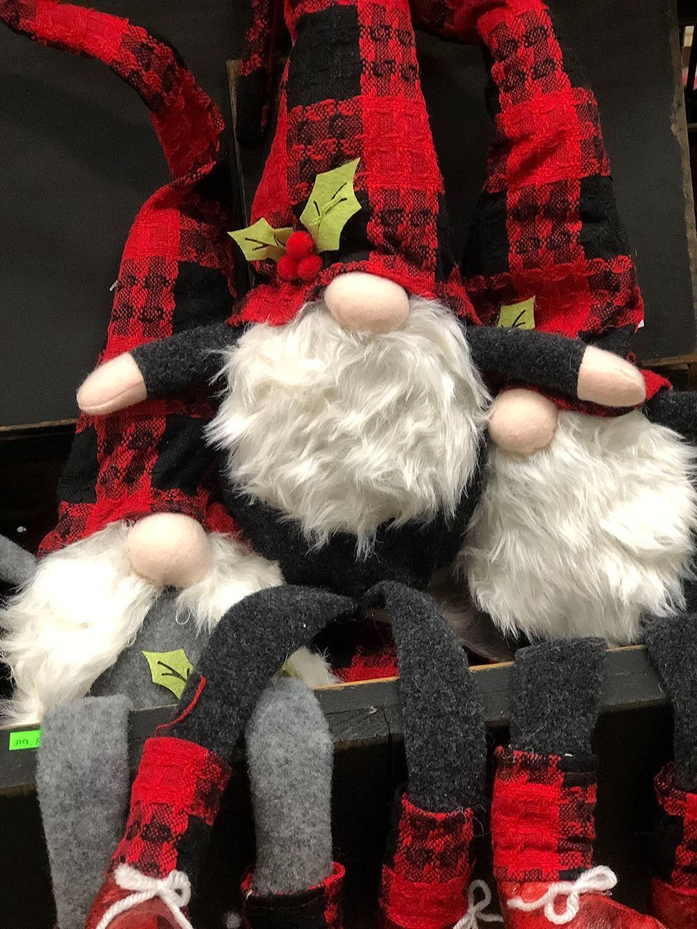 Three gnomes with plaid hats and white beards. Some have holly accents, with red and black accents.