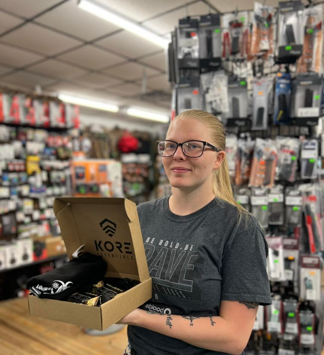 A woman is holding a box that says kore on it