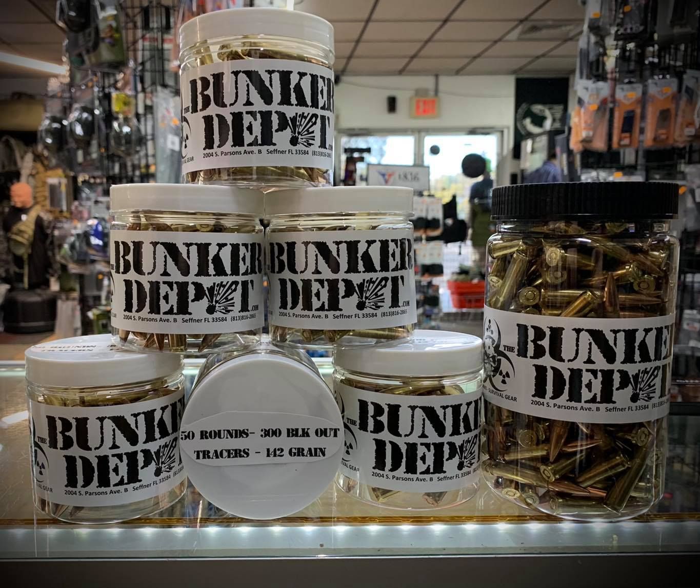 Several jars of bullets are stacked on top of each other in a store.