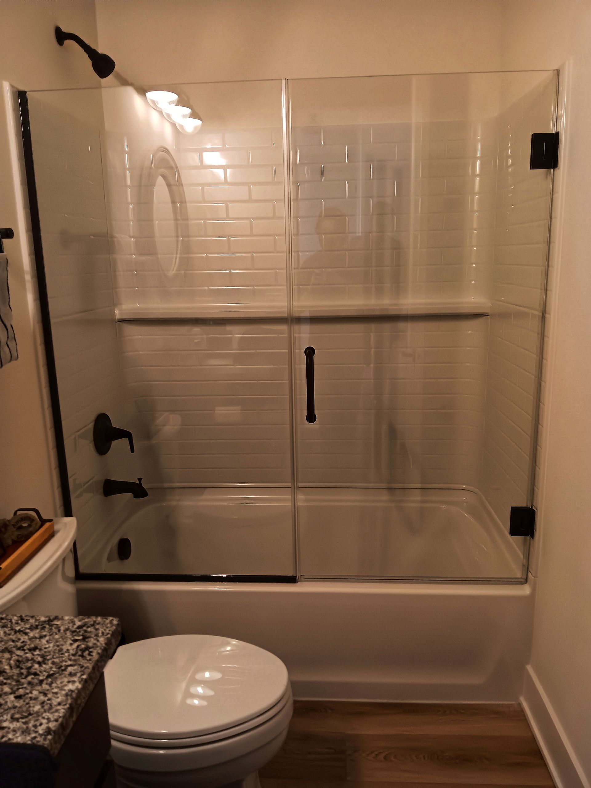 Bathroom with a glass shower door and a toilet.