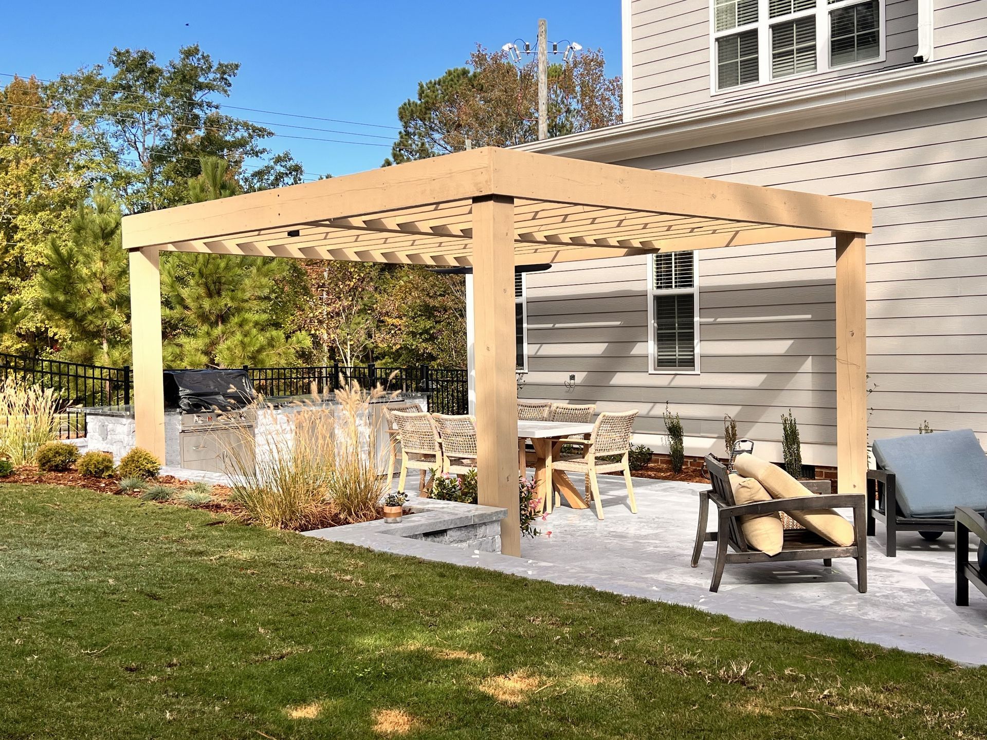 There is a pergola in the backyard of a house
